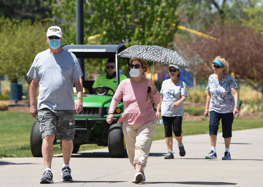 Not all lunchtime walkers wear masks at E. B. Rains, Jr. Memorial Park in Northglenn on Tuesday, May 19. The Northglenn City Council adopted a directive requiring mask for people out in public at their May 18 meeting.